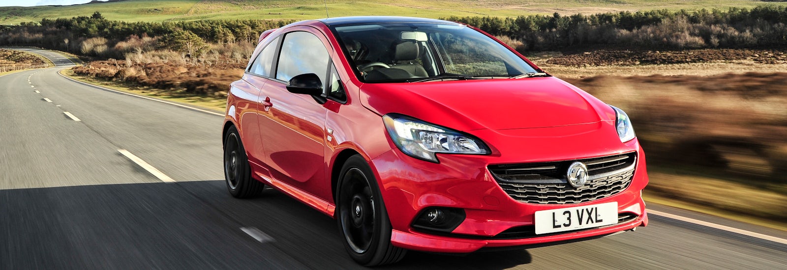 vauxhall corsa red driving front