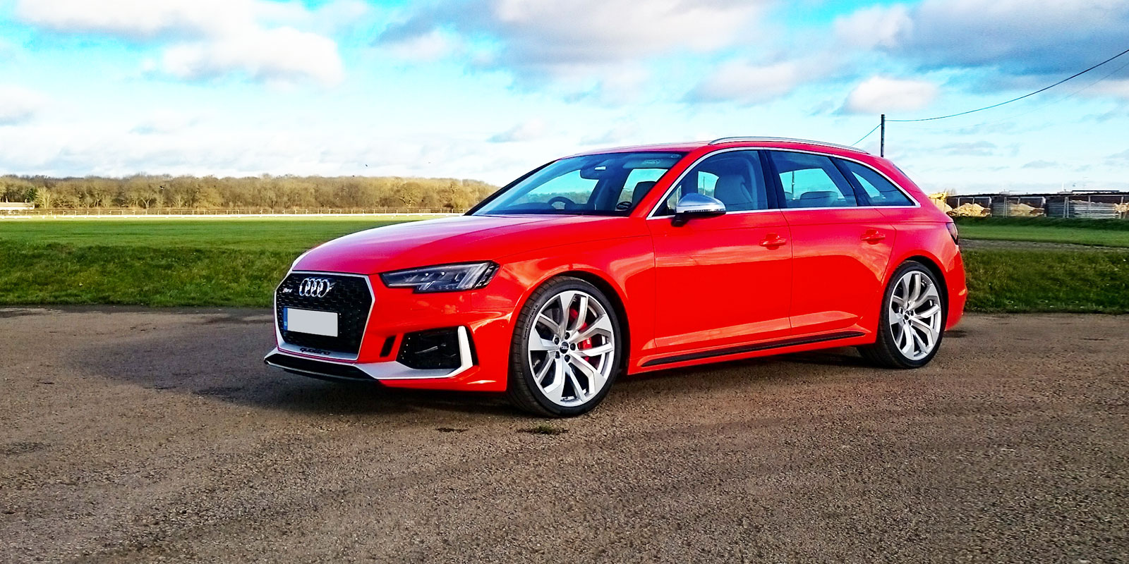 audi rs4 avant estate red parked front lead 1